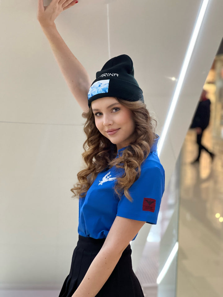 Czarina Sasha (@sashastarynets) is wearing a Black Beanie with blue sky design and white embroidered CZARINA from Czar Clothing