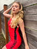 American Model Czarina Kate is wearing a red bodycon dress with black stripe and black czarina text for Czar Clothing