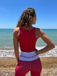 Italian Model Czarina Claudia wearing a red matched set with a white waistband on a sicilian beach for Czar Clothing. Sicily, Italy 